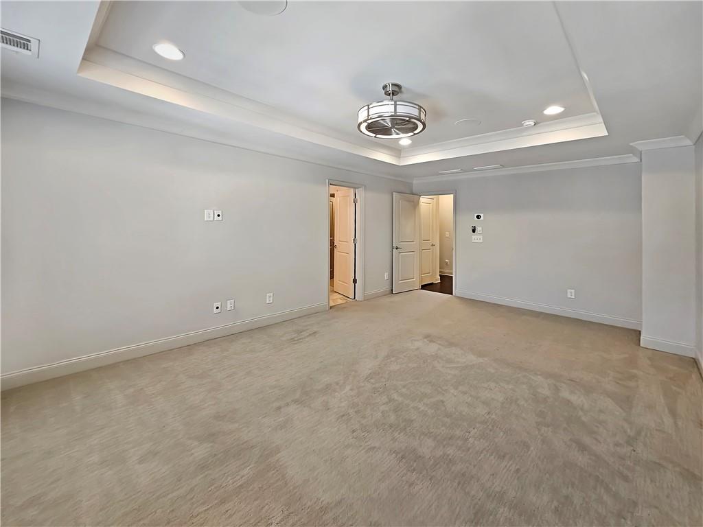 2142 Coventry Drive Brookhaven, GA 30319 - Photo 32 of 52 an empty room with a chandelier fan and windows