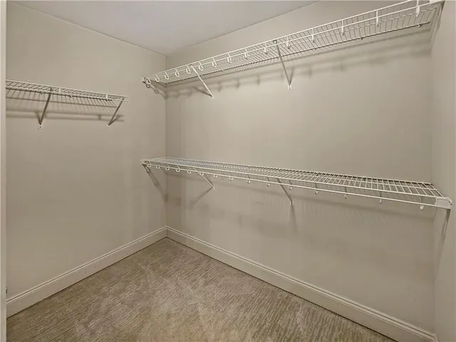 an empty room with windows and fireplace