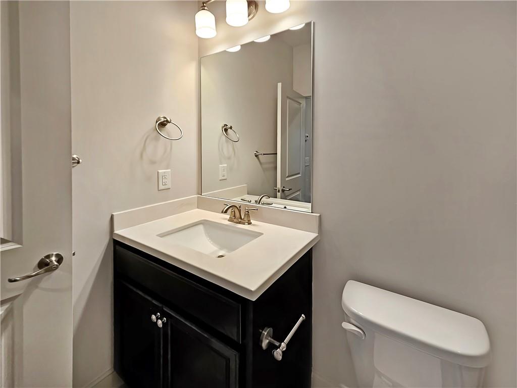 2142 Coventry Drive Brookhaven, GA 30319 - Photo 43 of 52 a bathroom with a sink a toilet a mirror and vanity