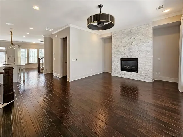 a view of a kitchen with a dishwasher a fireplace and wooden floor