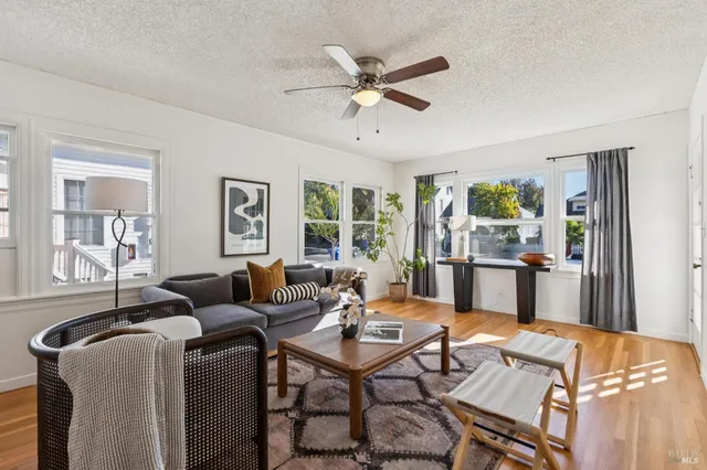 a living room with furniture a table and a window