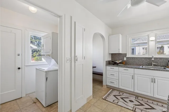 a spacious bathroom with a double vanity sink a mirror and a window