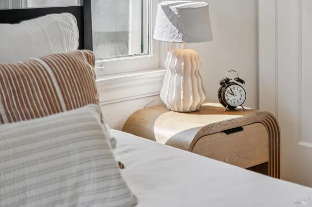 a bedroom with two beds and a window