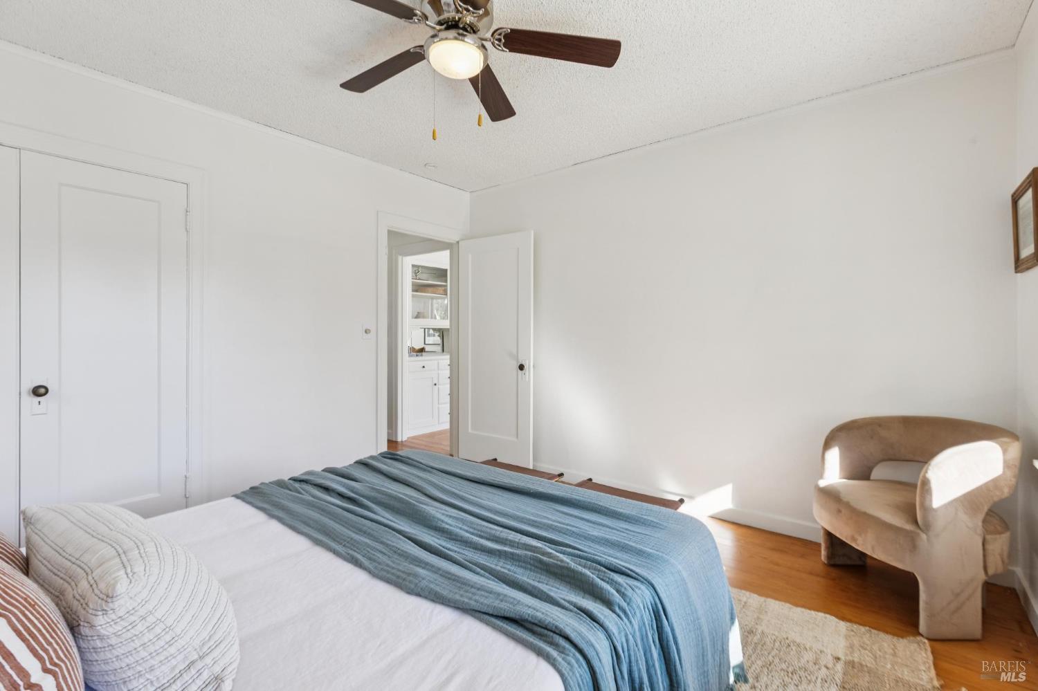 539 Randolph Street Napa, CA 94559 - Photo 23 of 35 a bedroom with a bed and a chandelier