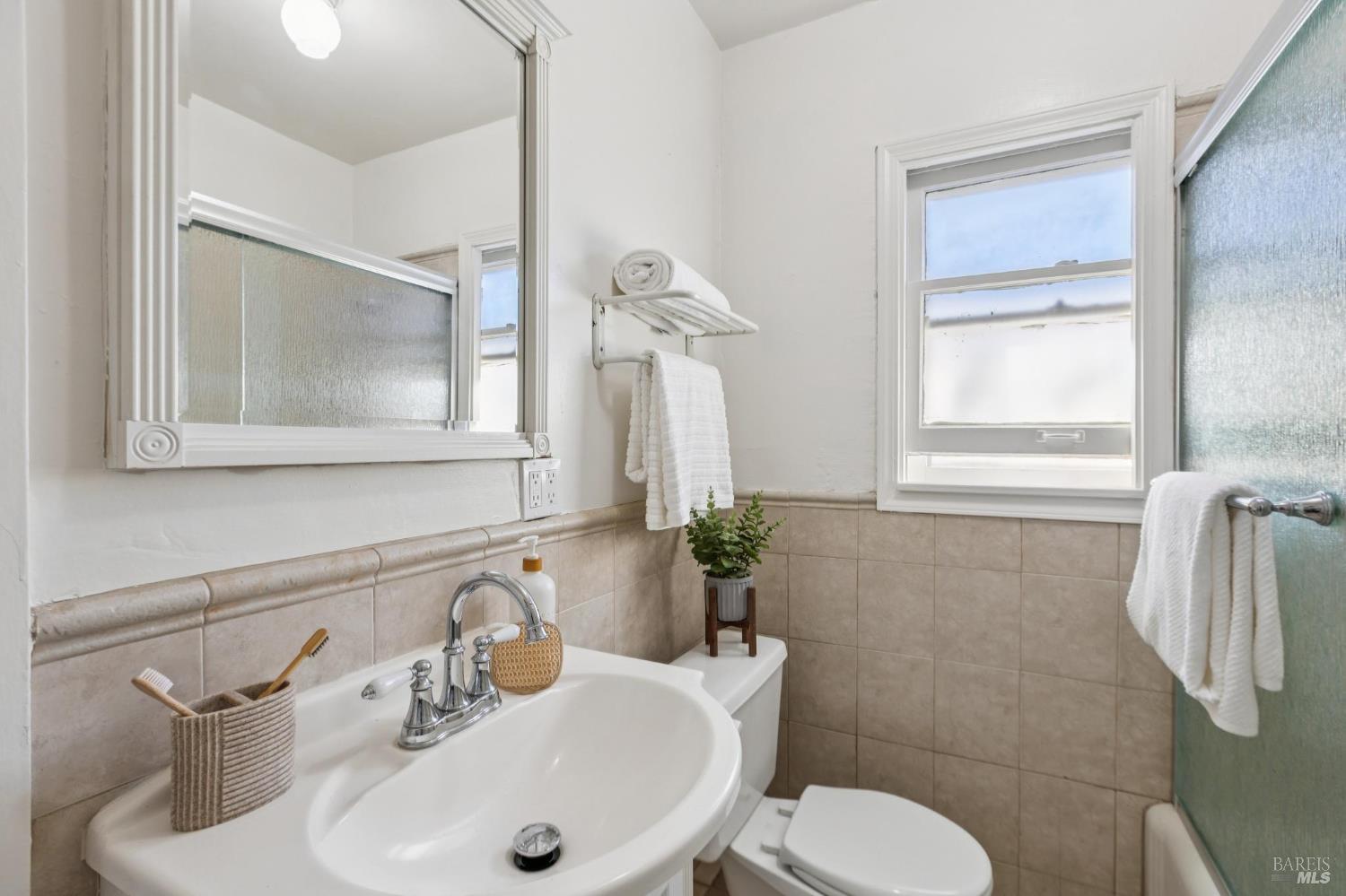 539 Randolph Street Napa, CA 94559 - Photo 25 of 35 a bathroom with a sink mirror and toilet