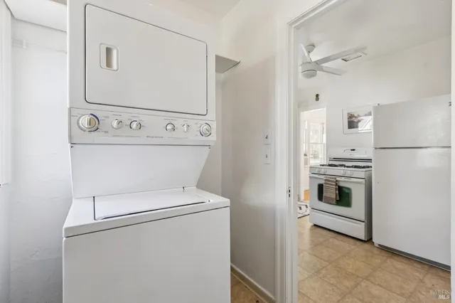 a view of washer and dryer with kitchen in the background