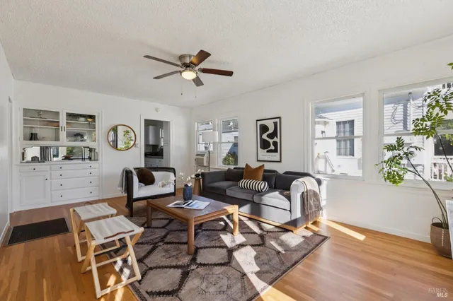 a living room with furniture and wooden floor