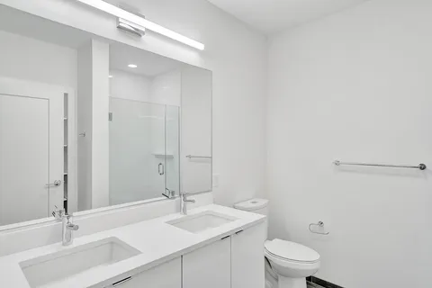 a bathroom with a sink a toilet and mirror