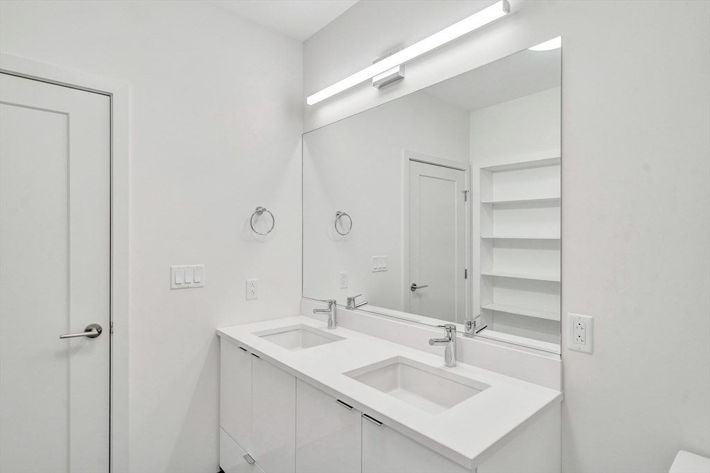 45 Lewis Street, Unit 406 Boston, MA 02128 - Photo 13 of 26 a bathroom with a sink and a mirror