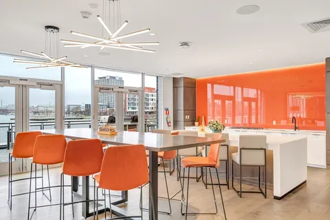 a dining table with chairs and floor to ceiling window