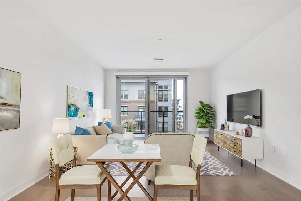 45 Lewis Street, Unit 406 Boston, MA 02128 - Photo 3 of 26 a living room with furniture and a flat screen tv