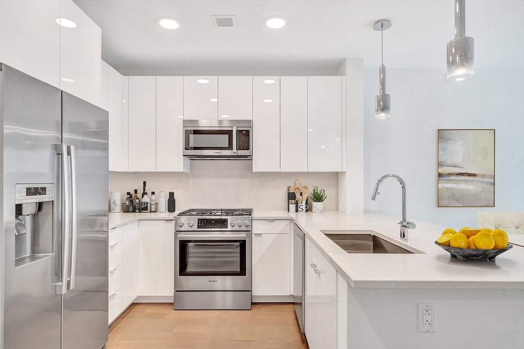45 Lewis Street, Unit 406 Boston, MA 02128 - Photo 4 of 26 a kitchen with a sink a stove and refrigerator