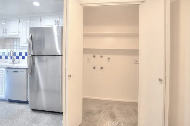 a kitchen with stainless steel appliances kitchen island sink refrigerator and microwave