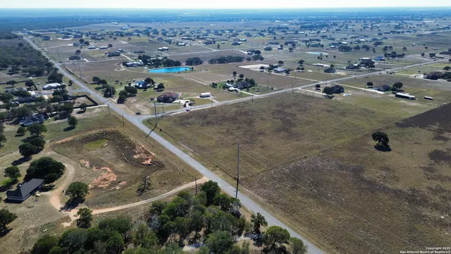 an aerial view of a house with a yard and garage