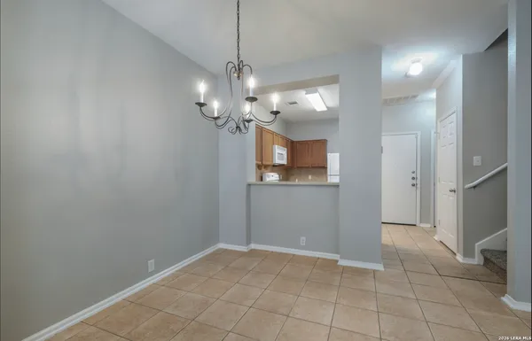 a view of a chandelier in a room with a mirror