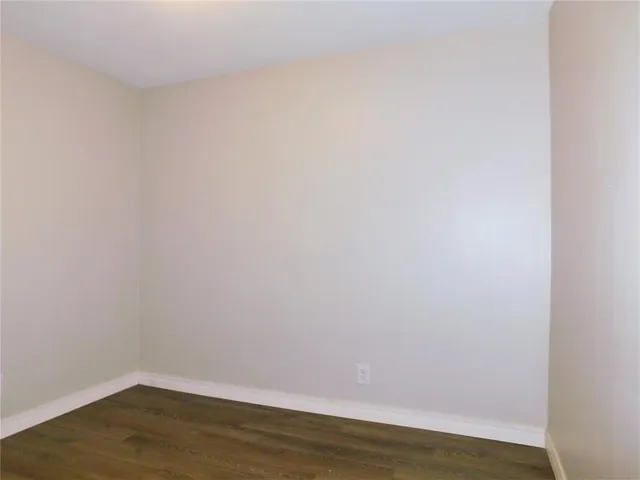 a view of a small space with wooden floor