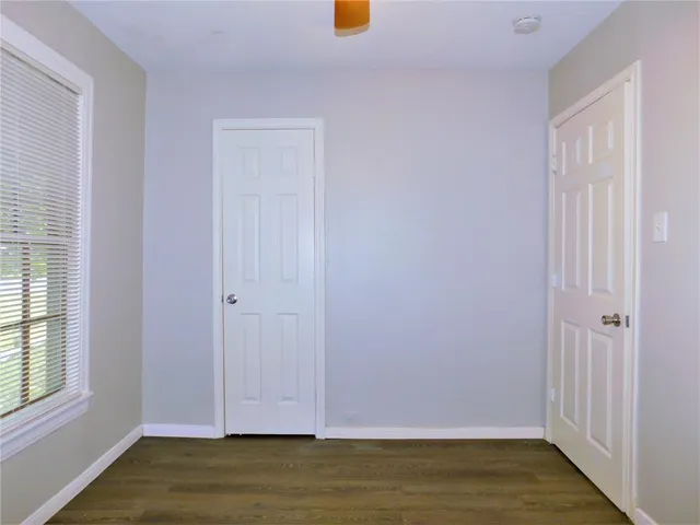a view of room with window and wooden floor