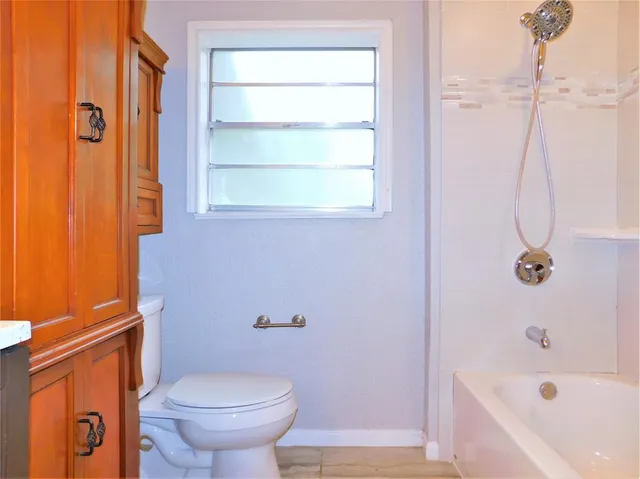 a bathroom with a toilet and a bathtub