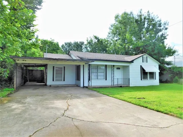 a view of a house with a yard and porch