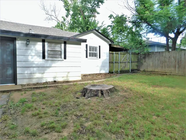 a backyard of a house with table and chairs