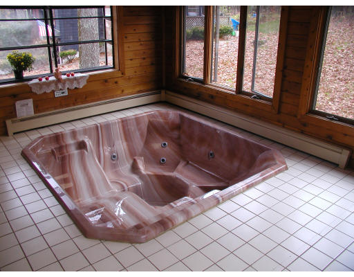 76 Wagon Wheel Road Dracut, MA 01826 - Photo 8 of 10 a bathroom with a bathtub and next to a window