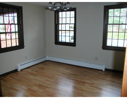 76 Wagon Wheel Road Dracut, MA 01826 - Photo 9 of 10 an empty room with wooden floor and windows