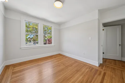 a view of a room with wooden floor and window