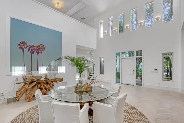 a living room with furniture a flat screen tv and a large window