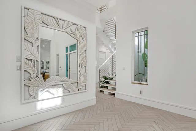 a view of an empty room with a window and fire place