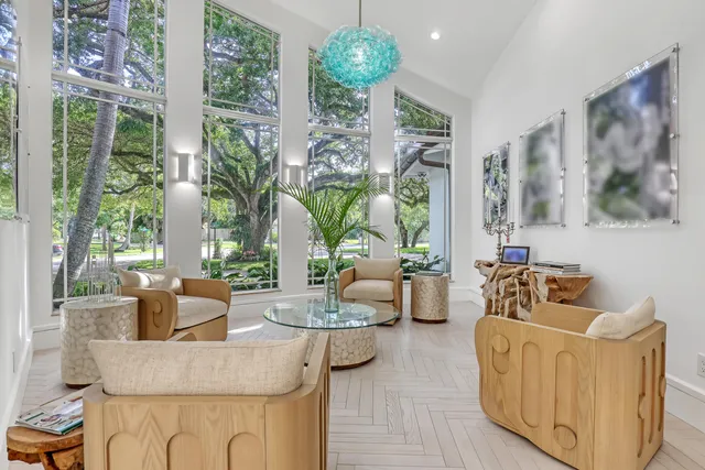 a large kitchen with kitchen island a sink and a refrigerator