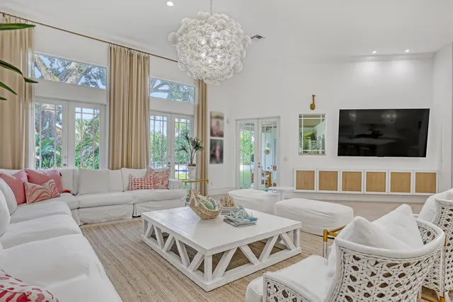 a spacious bedroom with a bed and large windows