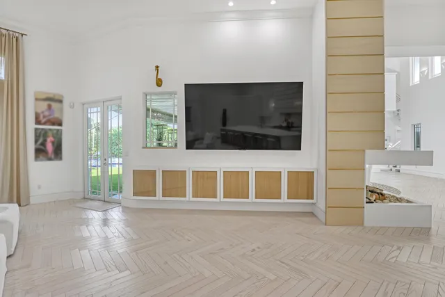 a living room with a bed furniture and a large window