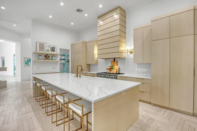 a spacious bedroom with a bed and a chandelier