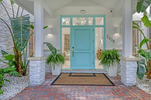 a living room with furniture and large windows