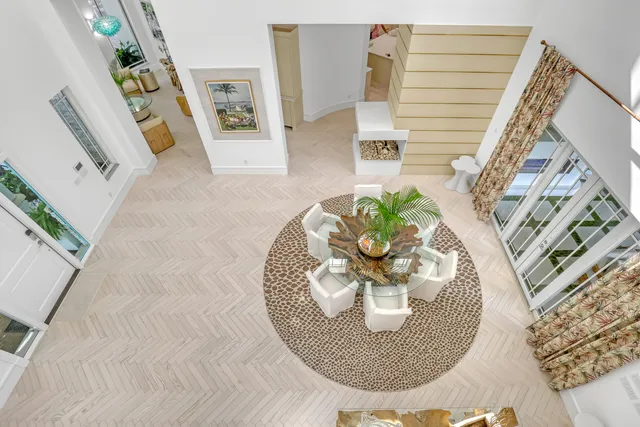 a spacious bedroom with a bed a dresser and potted plant