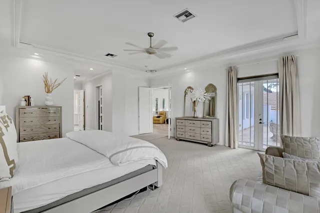 a view of a swimming pool with a table and chairs under an umbrella