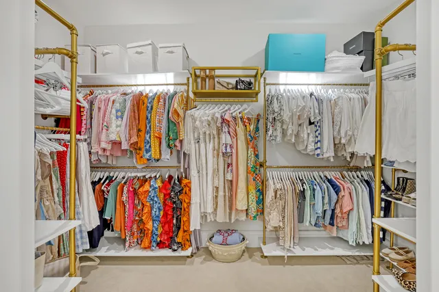 a view of a patio with table and chairs potted plants and a palm tree