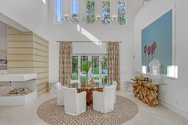 a kitchen with white cabinets and wooden floor