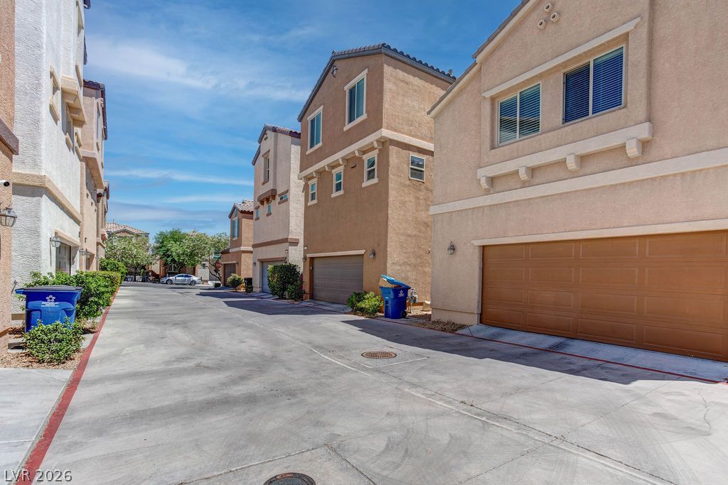 7724 Vibrant Thread Court Las Vegas, NV 89149 - Photo 42 of 43 A well-maintained concrete driveway leads to the attached garage of this multi-story residence.