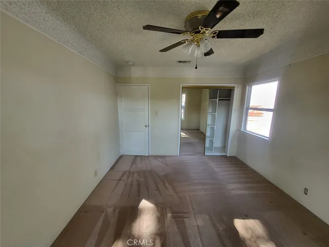 a view of a hallway with a chandelier fan
