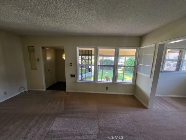 an empty room with large windows