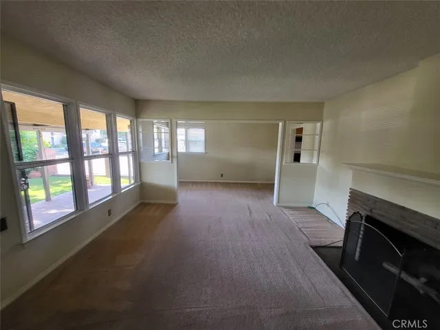 a view of empty room with a fireplace