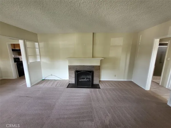 a view of an empty room with a fireplace