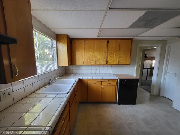 a kitchen with granite countertop cabinets and window