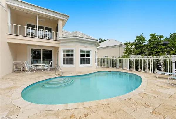 a view of a house with swimming pool and porch