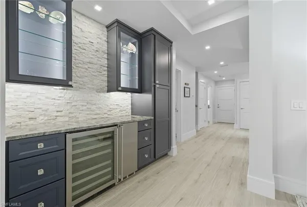 a spacious bathroom with a granite countertop sink and a mirror