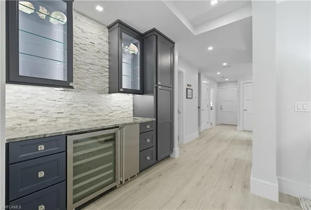 a spacious bathroom with a granite countertop sink and a mirror