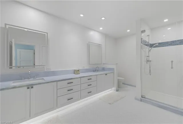 a bathroom with a granite countertop sink mirror and double