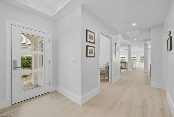 a view of a big room with wooden floor and windows