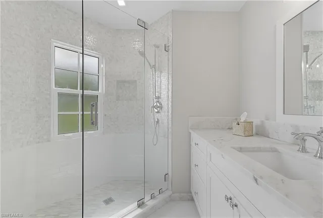 a bathroom with a shower sink and vanity